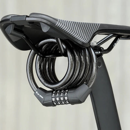 A black bicycle saddle lock with a triple dials combination lock and coiled steel cable, shown attached to a bicycle saddle.