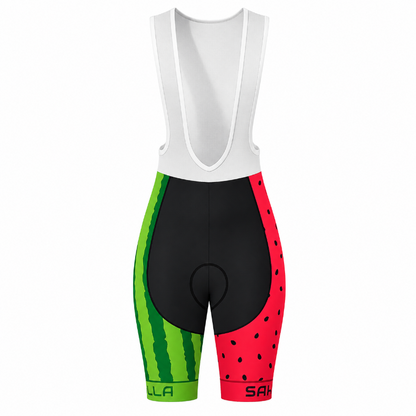 A pair of women's cycling bib shorts with a watermelon-themed print. The upper bib portion is solid white, while the leg sections feature a split design: one side has a green watermelon rind pattern, and the other has a red watermelon seed pattern.