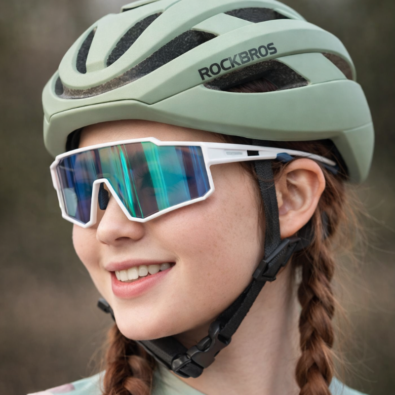 Person wearing a green helmet and reflective sunglasses.