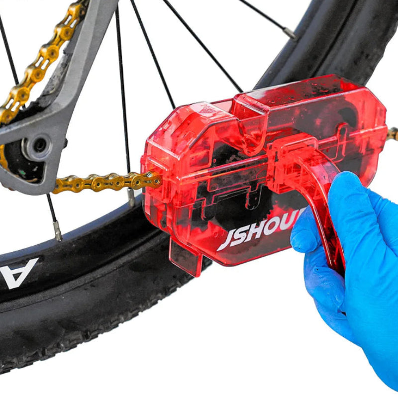 Bicycle chain cleaning tool being used on a bicycle.