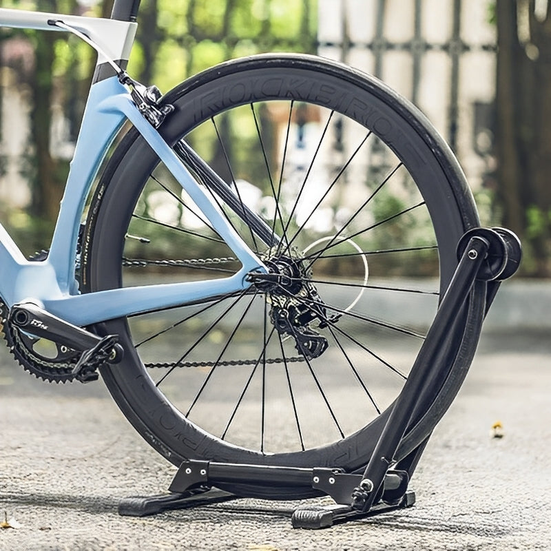 Bicycle wheel on a stand with a blurred outdoor background