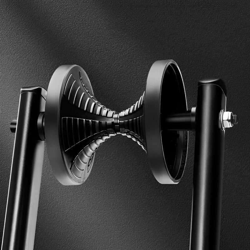 Close-up of a black metal stand with a textured circular component on a dark background