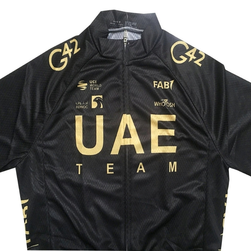 Black cycling jersey with gold text and logos, featuring 'UAE Team' branding.