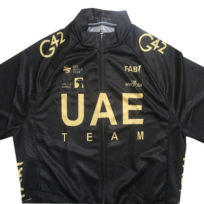 Black cycling jersey with gold text and logos, featuring 'UAE Team' branding.