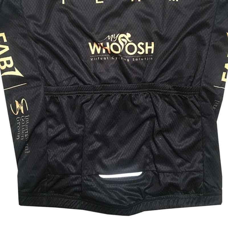 Black cycling shorts with gold and white branding on a white background