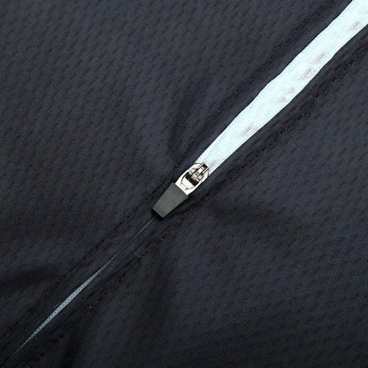 Close-up of a zipper on a textured black fabric background