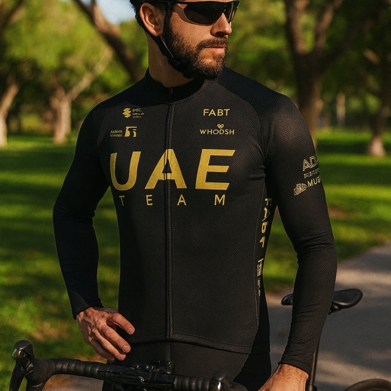 Man wearing a black cycling jersey with 'UAE Team' branding in a park setting