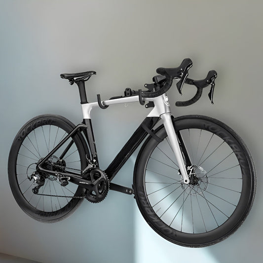 Black and white bicycle mounted on a gray wall