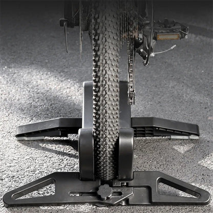 Bicycle tire on a floor stand with a close-up view of the tread pattern and chain.