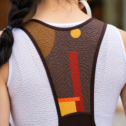 Back view of a person wearing a brown posture corrector brace with geometric red, yellow, and orange accents over a white athletic mesh top.