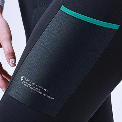 Close-up of a black athletic outfit with teal trim and a visible brand label.