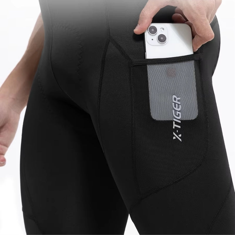 Person wearing black cycling pant with a phone pocket 
