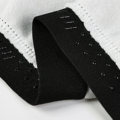 Close-up of a black belt with textured surface on a white background