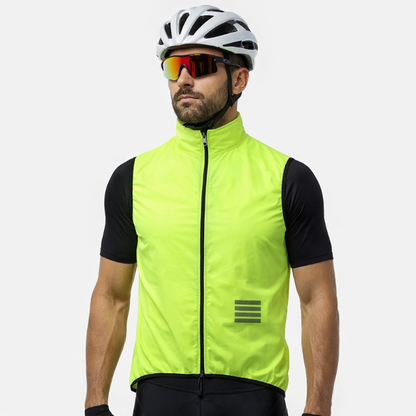 Man wearing a bright yellow cycling vest, black shorts, helmet, and sunglasses on a white background