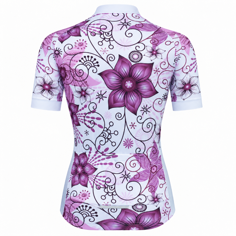 A women's short-sleeve cycling jersey shown from the back, featuring a white base with a vibrant purple and magenta floral pattern and black swirling vine details.