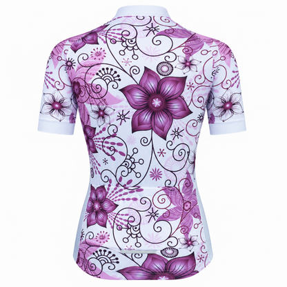 A women's short-sleeve cycling jersey shown from the back, featuring a white base with a vibrant purple and magenta floral pattern and black swirling vine details.