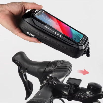 Hand holding a black phone case with 'Wild Man' branding, attached to a bicycle handlebar.