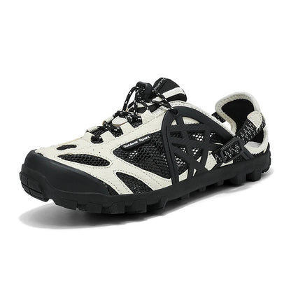 A single outdoor hiking shoe shown at a three-quarter angle on a white background. The shoe features a black and off-white color scheme with black mesh panels, black laces, and a black rugged sole.