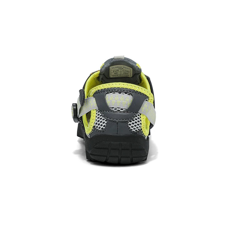 A single shoe shown from the back on a white background, featuring a dark gray and black design with bright neon yellow-green accents and reflective gray details.