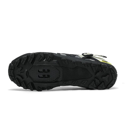 A close-up view of the black rugged sole of a cycling shoe, showing the tread pattern and heel design, on a white background.