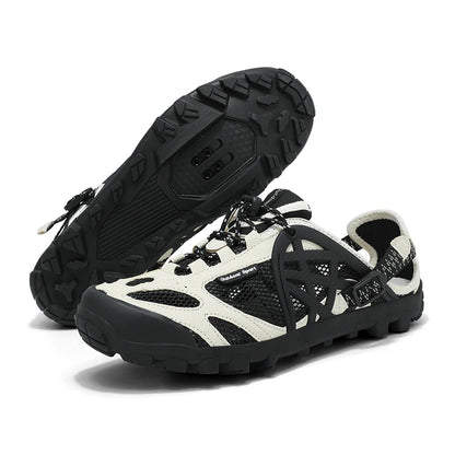 A pair of black and off-white outdoor water shoes with a rugged sole, shown on a clean white background. One shoe is positioned to show the textured black outsole, while the other is angled to display the side profile and mesh upper.