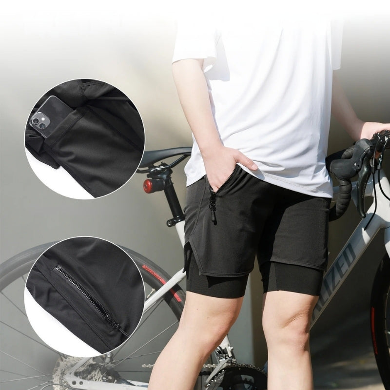 Person wearing black shorts with a close-up of a pocket and zipper detail, standing next to a bicycle.
