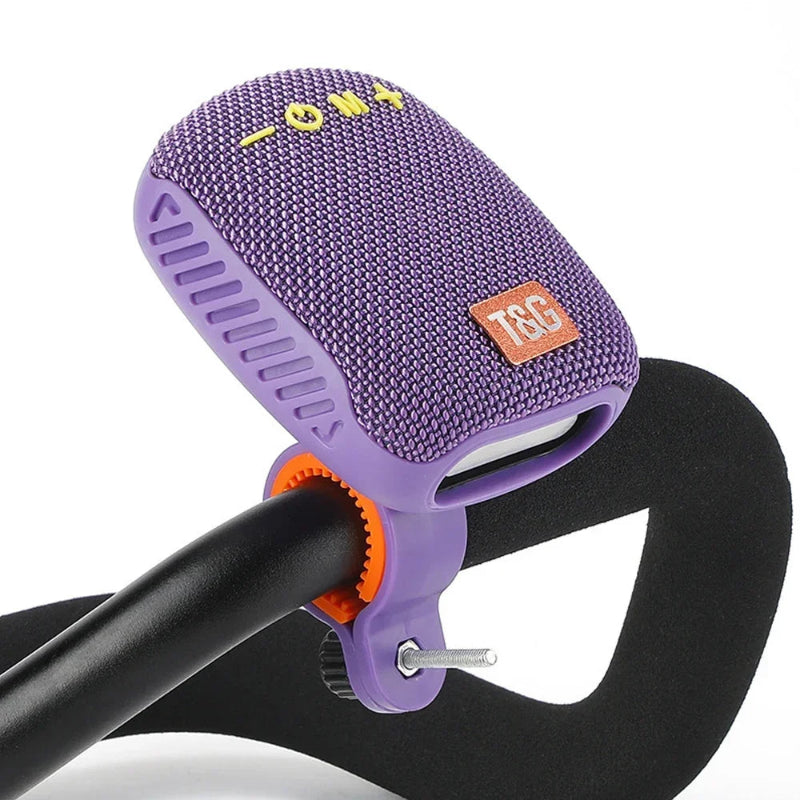 Purple Portable-Bluetooth-Speaker attached to a bicycle handlebar