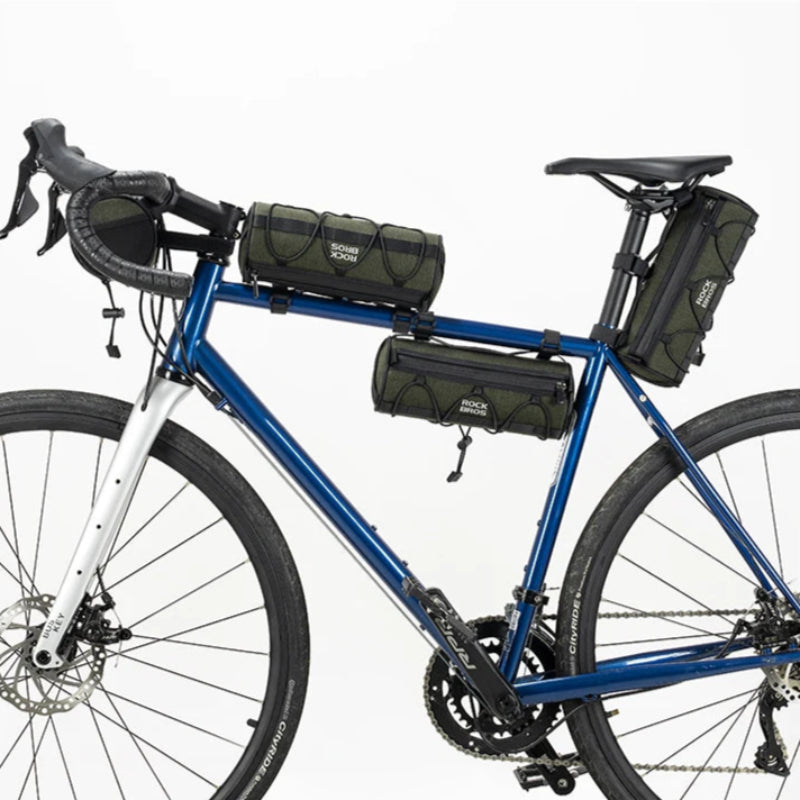 Blue bicycle with various bags attached on a white background