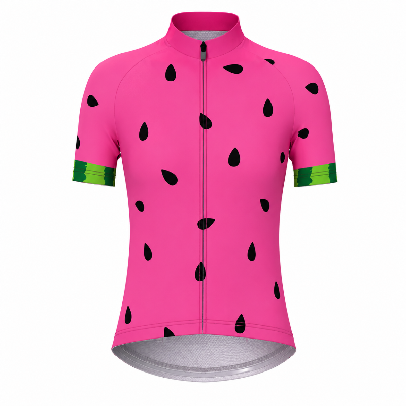 A short-sleeve cycling jersey in bright pink with a watermelon print, featuring black seed shapes and green striped cuffs, shown on a plain white background.