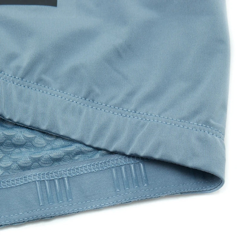 Close-up of blue fabric with lace trim on a white background