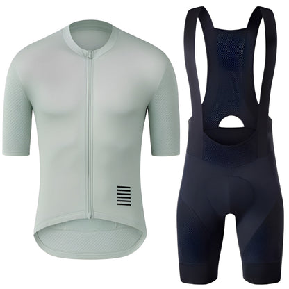 Light green cycling jersey and black bib shorts on a white background