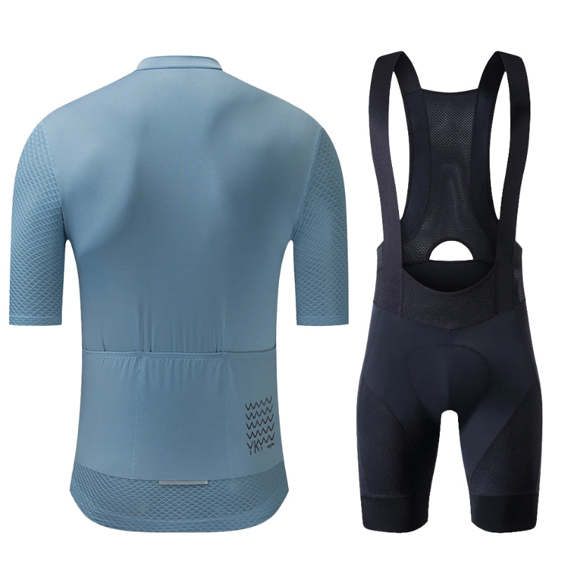 Blue cycling jersey and black bib shorts on a white background