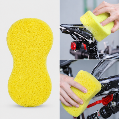 Yellow cleaning sponge being used on a bicycle