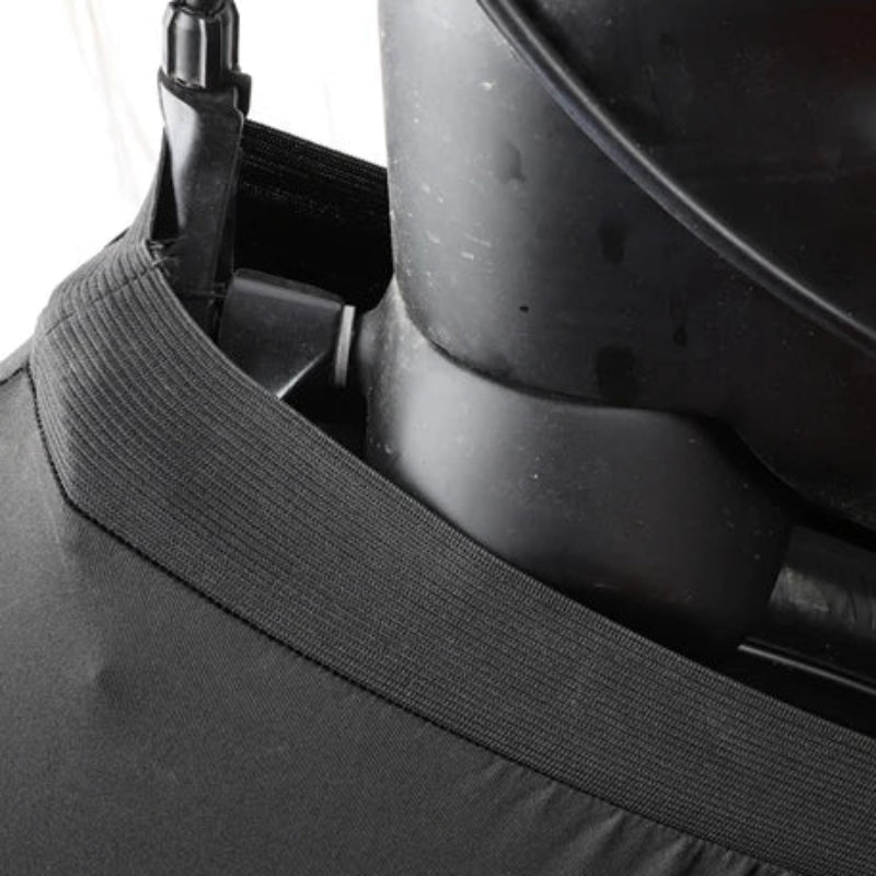 Close-up of a black helmet with a chin strap on a white background