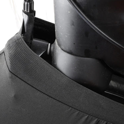 Close-up of a black helmet with a chin strap on a white background