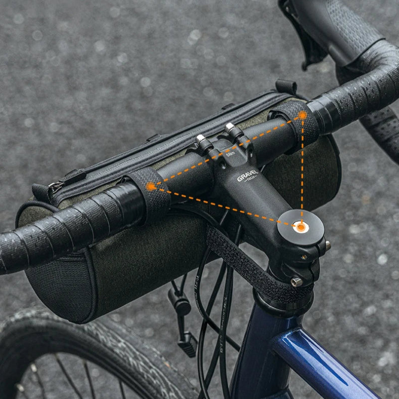Bicycle handlebar with a black bag and blue frame on a blurred road background