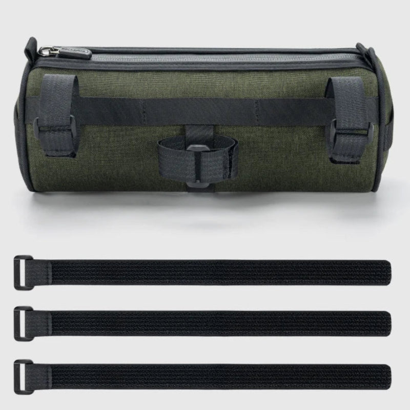 Green roll-up bag with black straps on a light gray background