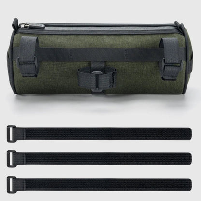 Green roll-up bag with black straps on a light gray background