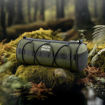 Green duffel bag on a mossy rock in a forest setting