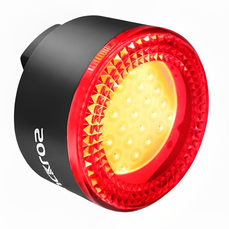 Red and black bicycle light with visible brand logo on a white background