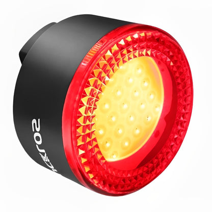 Red and black bicycle light with visible brand logo on a white background