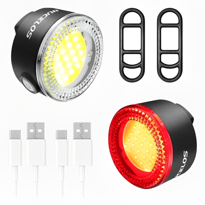Two bicycle lights, one black and one red, with additional components on a white background.