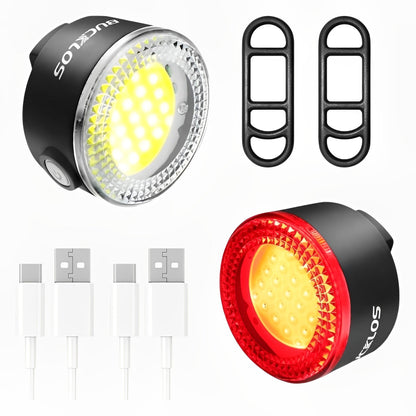 Two bicycle lights, one black and one red, with additional components on a white background.