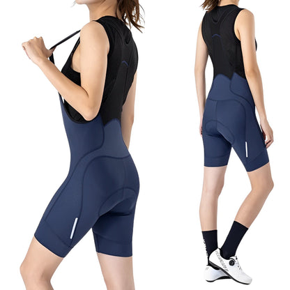 Woman wearing a black sleeveless top and blue cycling shorts on a white background