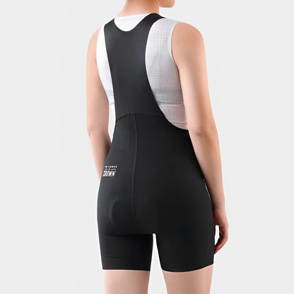 Person wearing a black and white cycling bib shorts on a plain background