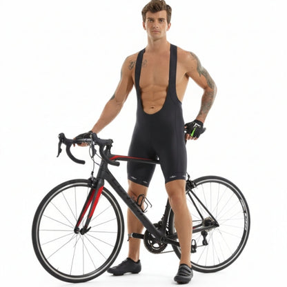 Man in black cycling bib shorts standing next to a bicycle on a white background