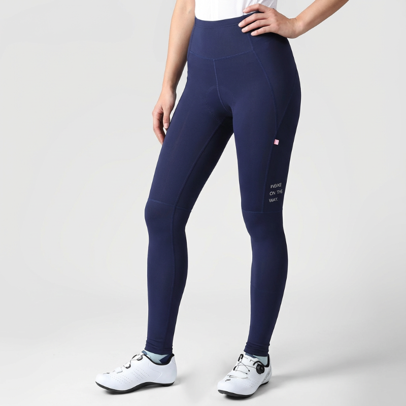Navy blue leggings worn by a person on a light gray background