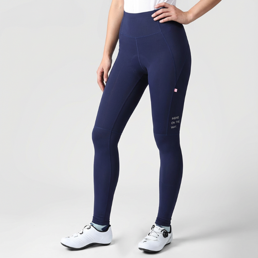 Navy blue leggings worn by a person on a light gray background