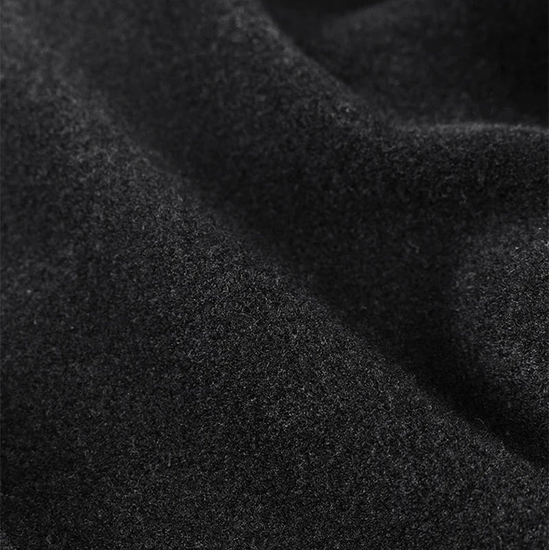 Close-up of black fleece fabric with text highlighting features