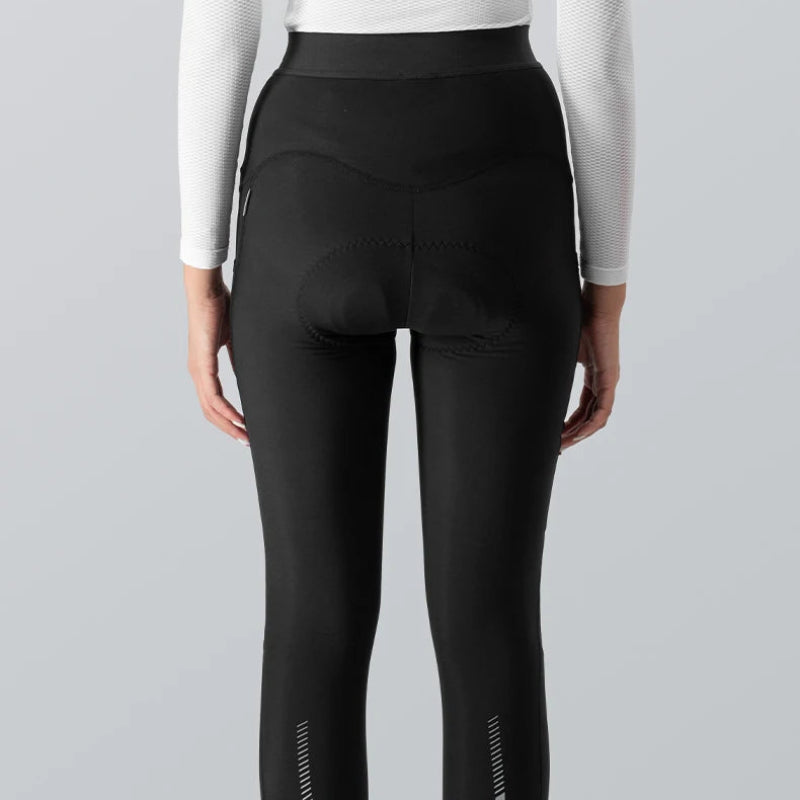 Person wearing black leggings with white accents on a gray background